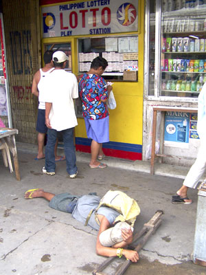 Beggar in front of lotto station