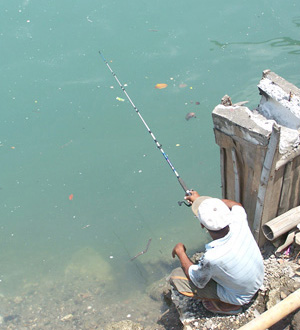 A man kills time fishing at Iloilo River on a Valentine's Day.