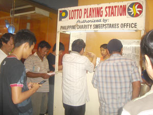 Bettors flock a lotto outlet inside the Atrium Mall