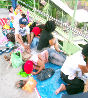 Parents and nannies wait for the dismissal of children from the Iloilo Central Elementary School