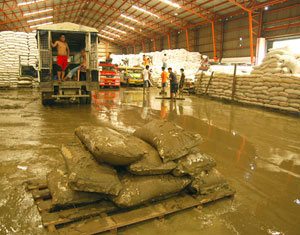 Workers clean the warehouse of the National Food Authority in Jaro, Iloilo City