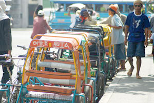 Pedicab drivers wait for passengers