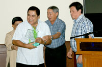 Bobby Sabino happily receiving his Recognition Award presented by Governor Joe Zubiri and Bob Cuenca.