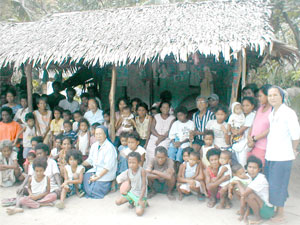 An aeta community in Sto. Bolabog, Brgy. Balabag, Boracay island pose with the sisters of Holy Rosary Parish Ati Mission (HRPAM)