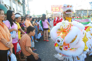 Spectators get amused by the lion and dragon dance performers.