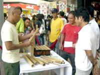 Biboy dela Cruz shows how the bamboo instruments are used.