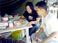 Cyline Manzano gives out a medicine to the patient.