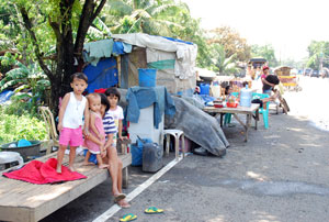 Some residents in Brgy. Dungon B, Jaro whose houses were reached by the water temporarily stayed beside the road instead of going to the evacuation centers.