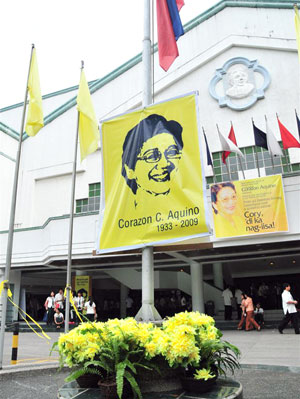 A Philippine flag in half-mast, yellow flags, ribbons and flowers and Cory Aquino posters adorn the entrance the University of St. La Salle in Bacolod City as a tribute to the icon of democracy.