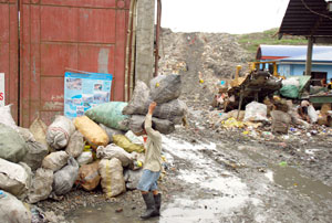 A man gathers recyclables which they have collected from the Calajunan dumpsite in Mandurriao, Iloilo City