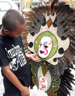 A boy touches a colorful mask being sold in downtown Bacolod City.