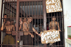 Inmates of the Iloilo Rehabilitation Center (IRC) display placards