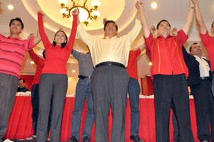 Liberal Party chair Senator Franklin Drilon raises the hands of candidates under what he called the “unity ticket”