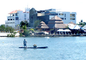 A fisherman at Iloilo River looks at the buildings and commercial establishments as he passes by to search for a good area to catch fish.