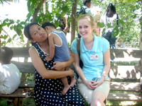 Alyssa poses with a woman and a child during a trip to a barangay.