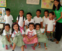 Day care students pose with teacher Mayflor.