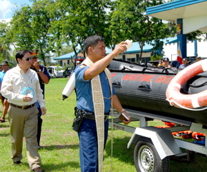 BLESSING. A police chaplain blesses the brand-new rubber boat