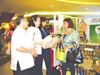 CHECK THIS OUT. DTI 6 Officer-in-Charge Wilhelm Malones, Delia Jarantilla, Valeria Maravilla, president of SMED; and Anilao Mayor Hon. Matet Debuque check out some of the products at the Otop Fair 2010.