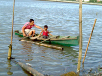 A father and son sail along the river in Brgy. San Juan, Molo district as Mayor Jed Patrick Mabilog orders the removal of illegal fishpens in Iloilo River by mid-September. 