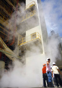 Workers of the coal-fired power plant of the Panay Energy Development Corp. in La Paz, Iloilo City check the steam coming out of the vent during the re-testing last Friday.