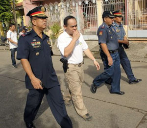 Chief Supt. Cipriano Querol Jr., police regional director, (left) and PDEA 6 chief Paul Ledesma (2nd from left) walk along a street in Brgy. Bakhaw